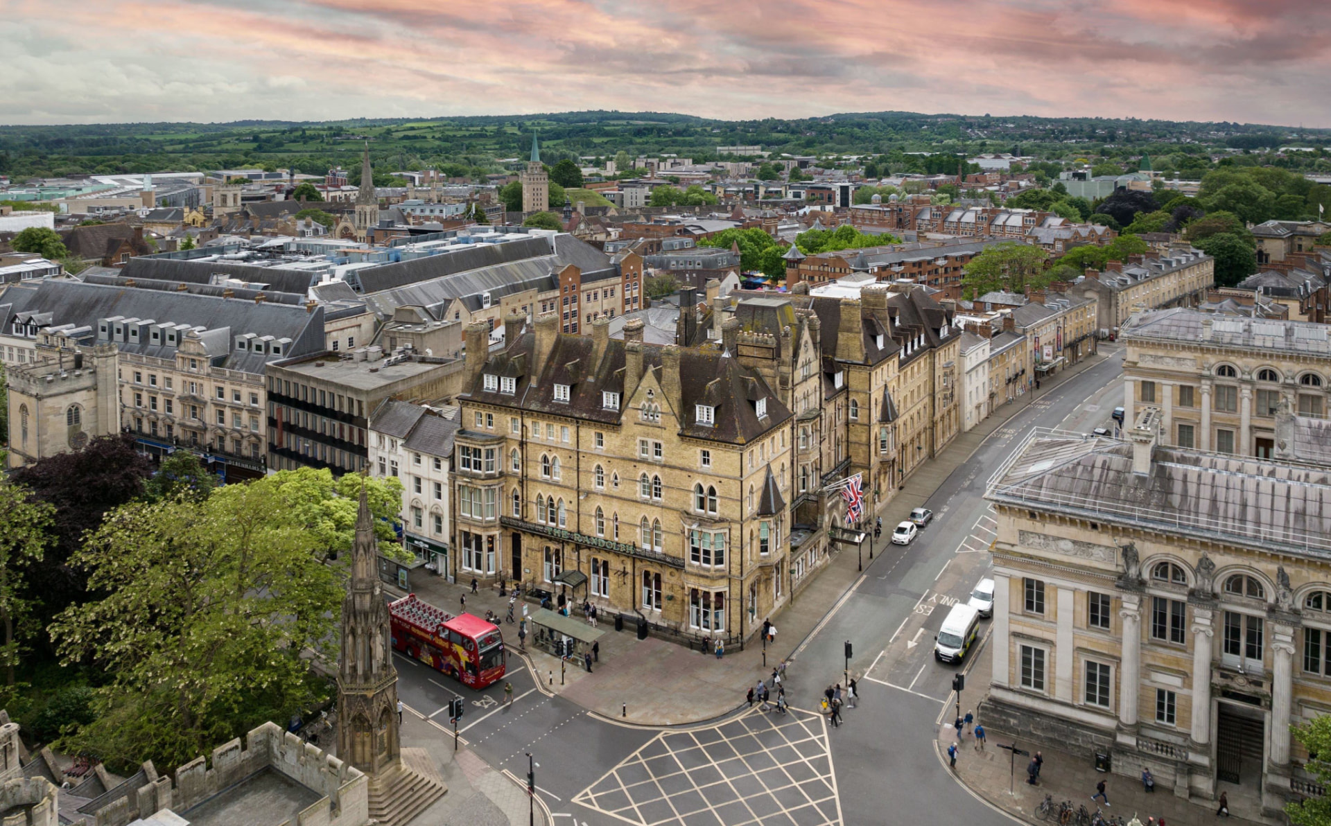 Aerial view of Oxford's historic city centre, with the Randolph Hotel and surrounding college spires visible in warm afternoon light.